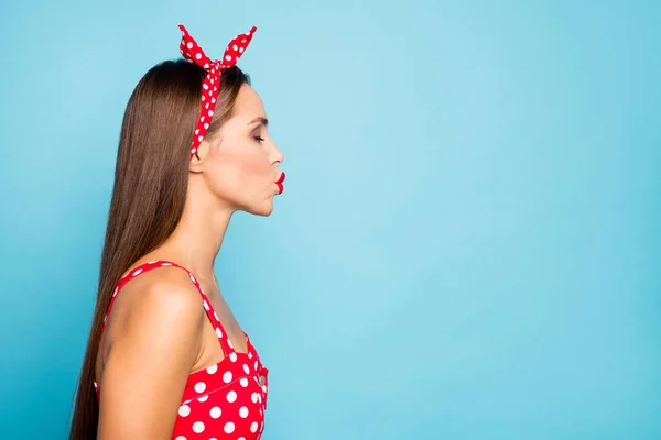 Close-up profile side view portrait of her she nice-looking attractive lovely lovable straight-haired girl sending air kiss cupid amour isolated on bright vivid shine vibrant blue color background