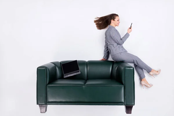 Top above high angle view vertical full body profile side photo ceo girl sit leather couch use smartphone social network boss wear formal high-heels flatlay isolated white color background