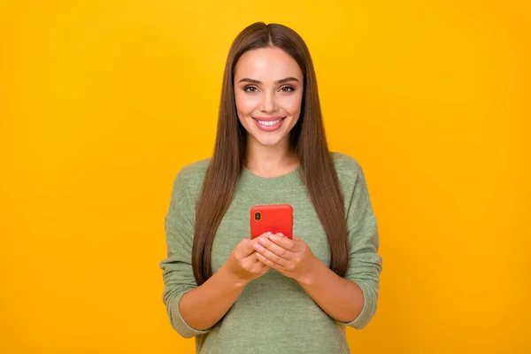 Portrait of positive cheerful girl use cellphone enjoy blogging post comment social media news wear style trendy sweater isolated over bright color background — Stock Photo, Image