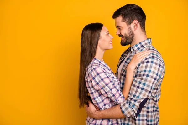 Foto de perfil encantadora dama guapo chico toothy sonriente ternura mirada ojos amor emociones abrazo pie cerca va a besar desgaste casuales camisas a cuadros aislado color amarillo fondo —  Fotos de Stock