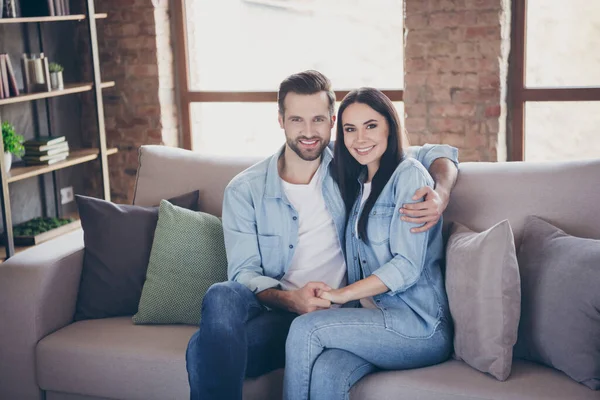 Portrait of positive cheerful spouses man woman hug embrace enjoy quarantine stay home together sit couch in house room indoors — Stock Photo, Image