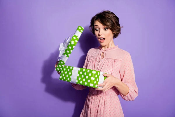 Portrait of astonished girl get receive gift box on anniversary party open impressed scream wear polka-dot outfit isolated over vivid color background — Stock Photo, Image
