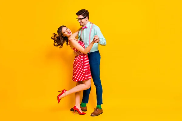 Full size photo of two people girl guy dance ballroom hold hand enjoy wear susenders stilettos dotted blue shirt green socks pants isolated over bright shine color background — стоковое фото