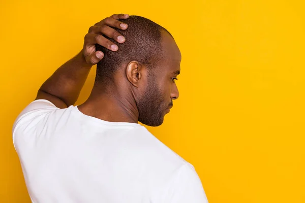 Close-up rear back behind view portrait of his he nice attractive serious guy touching hairdo care skincare neat grooming service isolated over bright vivid shine vibrant yellow color background — Stock Photo, Image