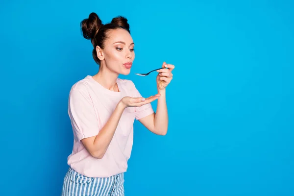 Photo of pretty lovely lady two funny buns blowing spoon hot soup meal cooking tasty meal overjoyed hungry wear casual pink t-shirt isolated bright blue color background — Stock Photo, Image