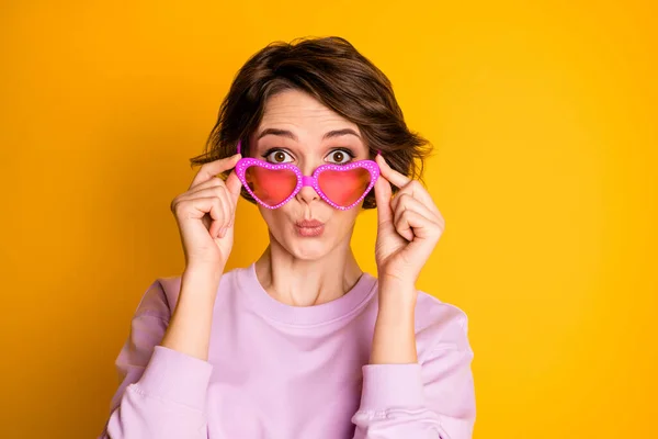 Close up photo of astonished youth girl look good incredible bargain news information cant believe her eyes touch heart shape specs wear pullover isolated over vibrant color background — Stock fotografie