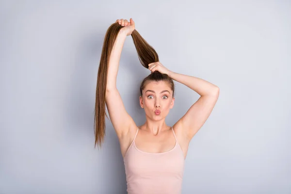 Close-up portrait of her she nice-looking attractive lovely pretty cheerful funky brown-haired girlfriend making ponytail sending air kiss isolated on light gray pastel color background — Stock Photo, Image