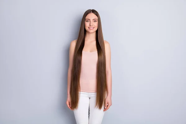 Photo of charming perfect appearance model lady toothy smiling demonstrating ideal neat long hairstyle wear beige singlet white trousers isolated grey color background — Stock Photo, Image