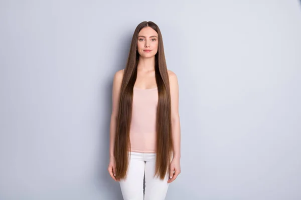 Photo of charming perfect appearance model lady not smiling demonstrating ideal neat long hairstyle wear beige singlet white trousers isolated grey color background — Stock Photo, Image