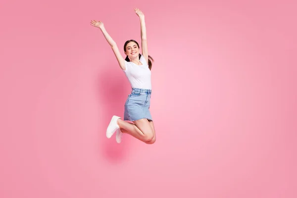 Full length body size view of her she nice attractive lovely charming pretty winsome cheerful cheery girl jumping having fun rising hands up isolated over pink pastel color background — Stock Photo, Image