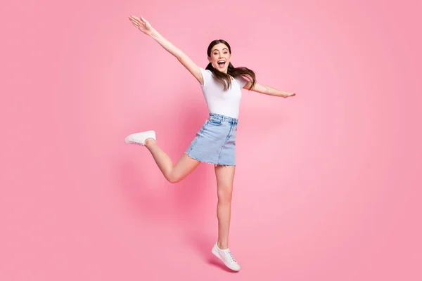 Full length body size view of her she nice attractive lovely charming pretty slender cheerful cheery girl jumping having fun walking isolated over pink pastel color background — ストック写真