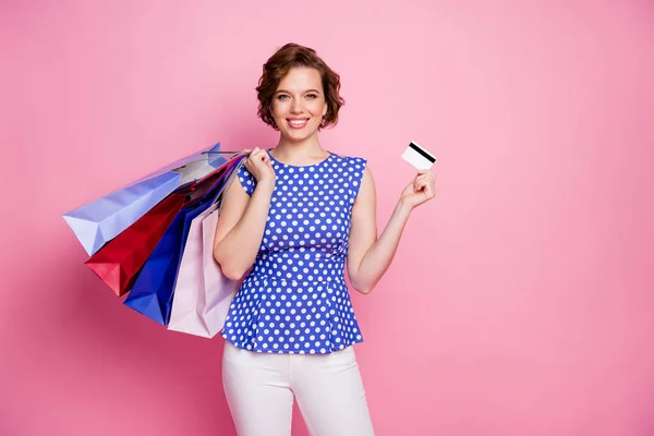 Portrait of her she nice attractive lovely lovable pretty charming glad cheerful cheery brown-haired girl carrying bags new things holding in hand plastic card isolated on pink pastel color background — Stock Photo, Image