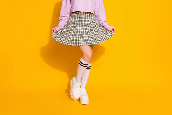 Cropped view of her she nice attractive fashionable slim fit feminine girl wearing checked skirt posing isolated on bright vivid shine vibrant yellow color background — Stock Photo, Image