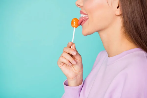 Cropped profile photo of funny lady hold lollipop hand sweets addicted person lick tasty candy tongue wear violet sweater isolated vibrant teal color background — Stock Photo, Image