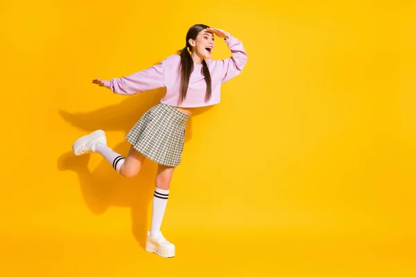 Full length body size view of her she nice attractive lovely fashionable cheerful cheery girl looking far away isolated over bright vivid shine vibrant yellow color background — Stock Photo, Image