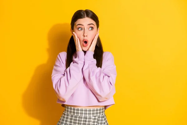 Portrait of astonished crazy girl hear incredible novelty look copyspace touch hands face scream wear stylish spring outfit isolated over vivid color background — Stock Photo, Image