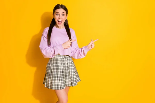 Foto de menina surpreso promotor ponto dedo copyspace direto maneira incrível anúncios promoção de vendas grito wow omg desgaste xadrez rosa jumper isolado brilhante brilho cor fundo — Fotografia de Stock