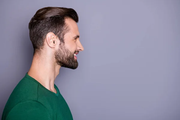 Closeup profile photo of macho attractive guy neat hairdo bristle smiling toothy good mood look side empty space wear casual green t-shirt isolated grey color background — Stock Photo, Image