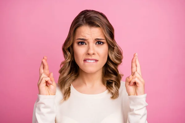 Close-up portrait of her she nice-looking attractive lovely charming pretty nervous wavy-haired girl crossed fingers praying waiting isolated over pink pastel color background — Stock Photo, Image