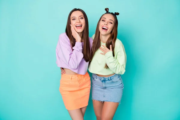 Portrait of two nice attractive lovely winsome charming glad amazed cheerful cheery girls having fun good mood isolated over bright vivid shine vibrant blue green turquoise color background — Stock Photo, Image