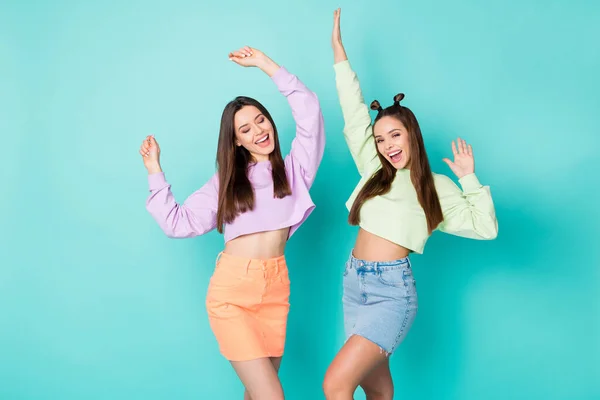 Portrait of two nice attractive lovely pretty ecstatic cheerful cheery girls having fun celebrating good day isolated over bright vivid shine vibrant blue green turquoise color background — Stock Photo, Image