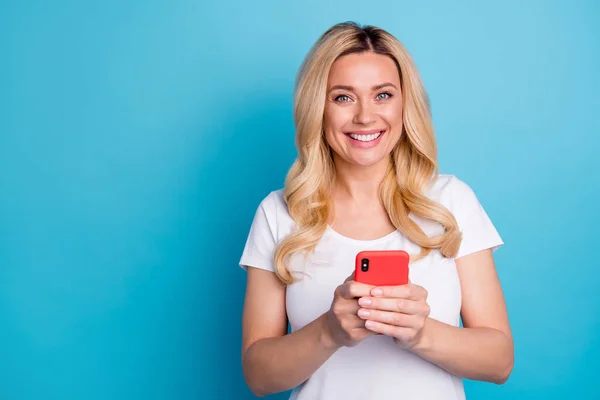 Portrait of positive cheerful woman use smartphone enjoy reading social network information wear good look clothes isolated over blue color background — Stock Photo, Image