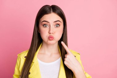 Close-up portrait of her she nice-looking attractive lovely pretty funky comic brunet girl pointing at cheek holding air pout lips isolated over pink pastel color background clipart
