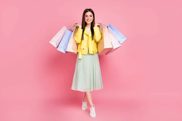 Full length body size view of her she nice-looking attractive pretty fashionable cheerful cheery girl carrying new things goods isolated on bright vivid shine vibrant yellow color background — Stock Photo, Image