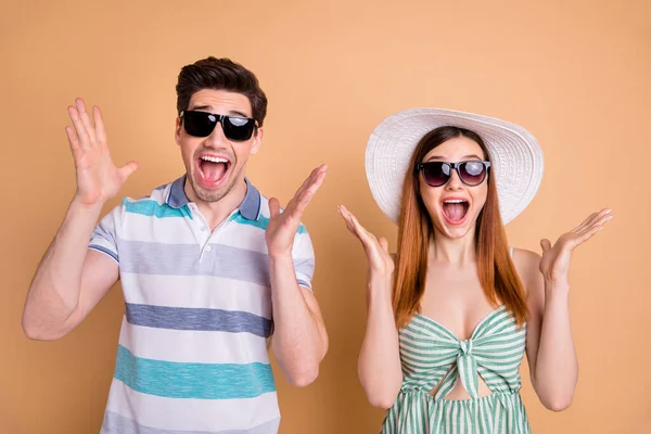 Photo of pretty lady handsome guy excited funky couple win free trip vacation journey addicted tourists wear casual summer clothes sun specs hat isolated pastel beige color background — Stock Photo, Image