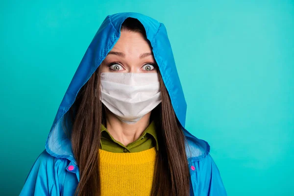 Closeup photo of attractive pretty lady stormy rainy weather street walk terrified eyes use medical protective mask wear casual outfit blue raincoat isolated teal color background — Stock Photo, Image