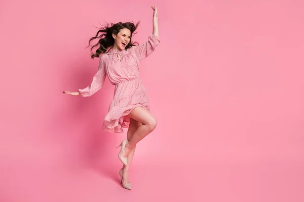 Full length photo of enthusiastic girl lady look good copyspace enjoy rejoice air wind blow haircut raise leg hand isolated over pink color background — Stock Photo, Image