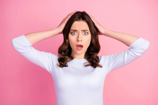 Foto de la señora atractiva sorprendida peinado ondulado escuchar malas noticias boca abierta ojos aterrorizados brazos mantenga la cabeza táctil desgaste casual jersey blanco aislado pastel rosa color fondo — Foto de Stock