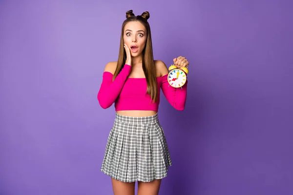 Photo of terrified lady two funny buns hold alarm clock late university college wear pink off-shoulders cropped top plaid short skirt isolated pastel purple color background — Stock Photo, Image