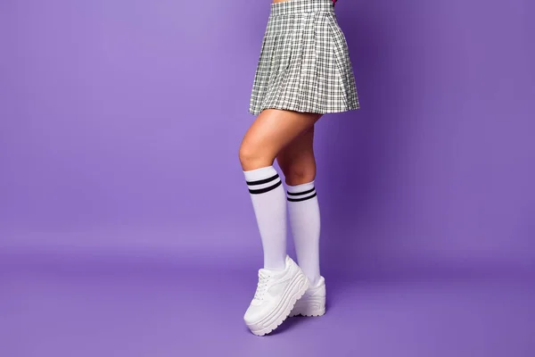 Cropped profile photo of lady showing cool stylish clothes outfit fit slim legs wear short plaid skirt long knee socks white shoes isolated pastel purple color background — Stock Photo, Image