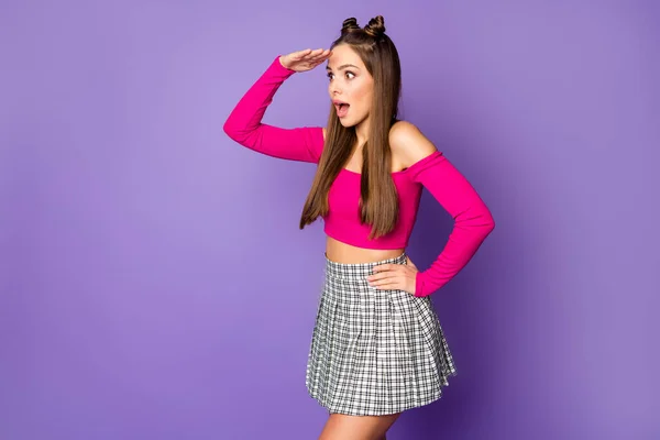 Profile photo of pretty millennial teen lady look far away open mouth see amazing view wear pink off-shoulders cropped top plaid skirt isolated pastel purple color background