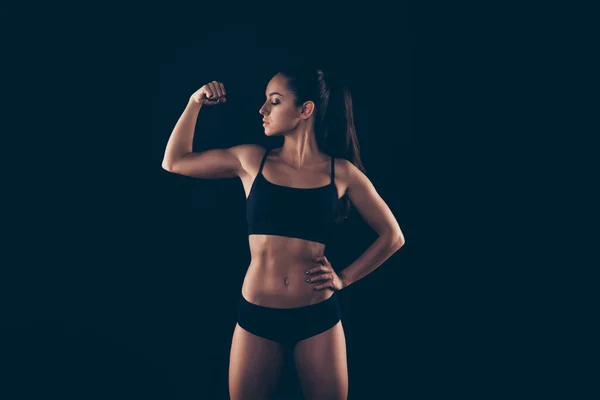 Portrait of her she nice-looking attractive content sportive perfect strong enduring lady fitness bikini model showing demonstrating powerful muscles isolated over black background — Stock Photo, Image