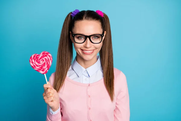 Portrait of cute lovely girl university student hold heart shape lollipop stick enjoy lesson break wear good look clothes isolated over blue color background — Stock Photo, Image