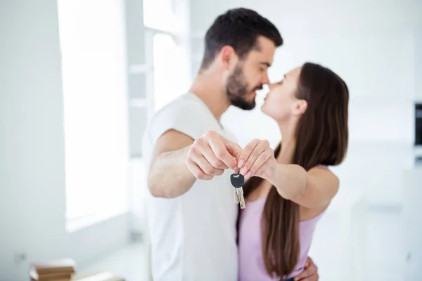 Profile side view portrait of his he her she nice attractive dreamy gentle married spouses hugging holding in hands key rent bank purchase space accommodation at flat light white interior — Stock Photo, Image