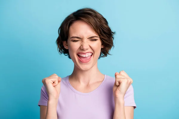 Portrait of delighted girl celebrate lottery fortune lucky win raise fists scream yeah wear good look mood clothes isolated over blue color background — Stock Photo, Image