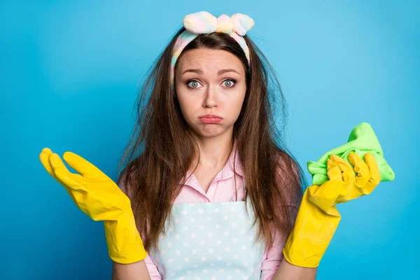 Close-up portrait of her she nice attractive offended puzzled exhausted brown-haired girl maid house keeper mess messy hair rubbing surface isolated on bright vivid shine vibrant blue color background