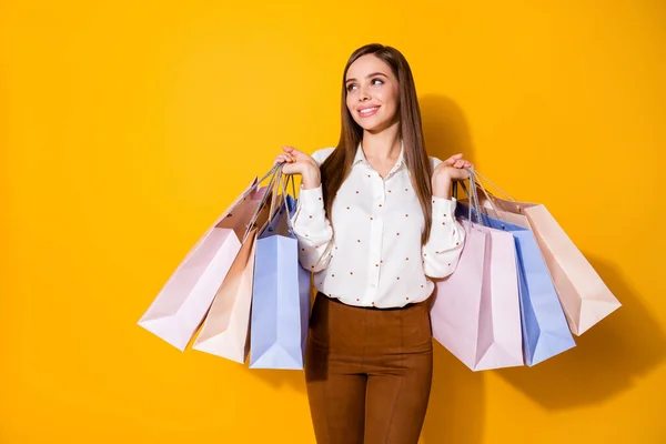 Portrait of her she nice-looking attractive lovely pretty fashionable dreamy cheerful brown-haired girl carrying new things clothes isolated bright vivid shine vibrant yellow color background — Stock Photo, Image