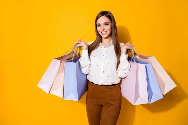 Portrait of her she nice-looking attractive pretty fashionable cheerful cheery brown-haired girl carrying new things season clothes clothing isolated bright vivid shine vibrant yellow color background — Stock Photo, Image