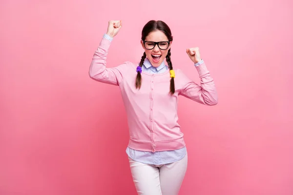 Photo of attractive student lady good mood self-confident person raise fists screaming celebrate money win wear shirt pullover specs trousers isolated pastel pink color background — Stock Photo, Image