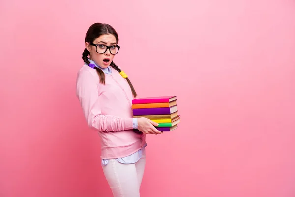 Profile photo of pretty shocked student lady hold heavy books pile prepare examination college university big homework library tired wear shirt pullover specs isolated pink color background — Stock Photo, Image