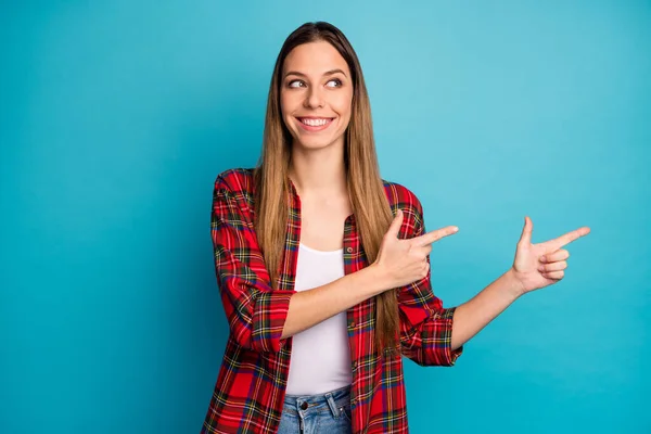 Portrait of her she nice attractive lovely pretty confident cheerful cheery long-haired girl wearing checked shirt demonstrating copy space isolated on bright vivid shine vibrant blue color background — Stock Photo, Image