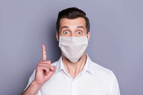 Close-up portrait of his he attractive healthy amazed guy wearing safety mask pointing up stop respiratory disease vaccine solution therapy viral influenza isolated over gray color background — Stock Photo, Image