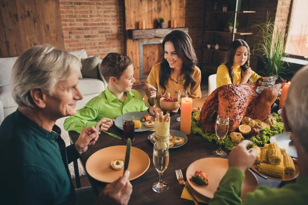 Portrait of nice attractive cheerful family parents grandparents sitting around served table eating homemade tasty delicious fresh dinner meal at modern loft brick industrial interior house — Stock Photo, Image