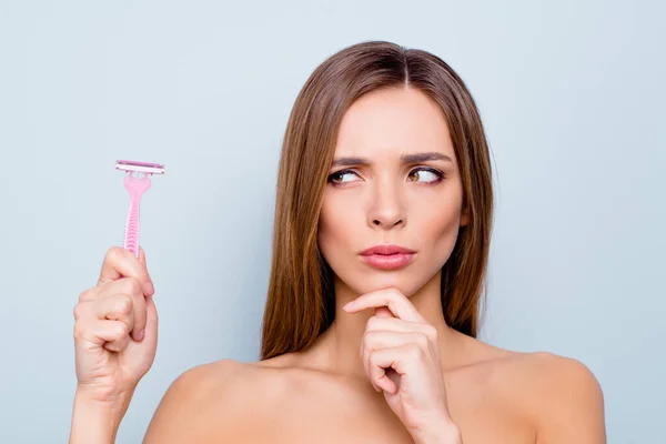 Close up photo portrait of pretty attractive charming cute lovely she her lady holding shaver in hand not sure about using it looking without trust isolated on grey background — Stock Photo, Image