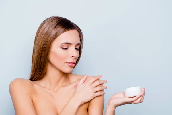 Close-up portrait of her lovely attractive well-groomed straight-haired lady holding in hands cream smooth shine clean clear flawless skin isolated over light gray background — Stock Photo, Image