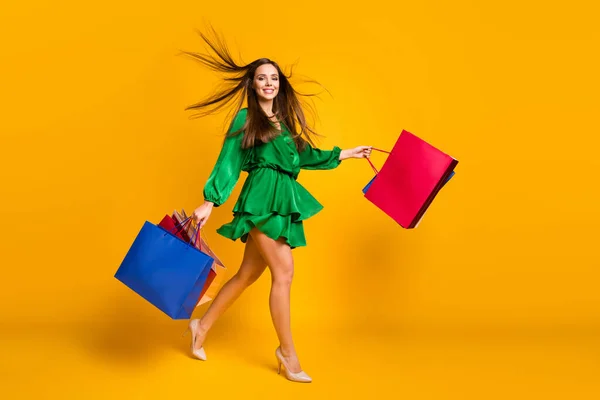 Full length body size view of nice attractive fashionable cheerful straight-haired girl carrying new clothes going isolated over bright vivid shine vibrant yellow color background — Stock Photo, Image